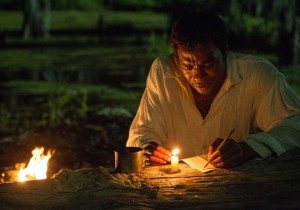 Ejiofor as Northup, trying to write a letter with berry juice