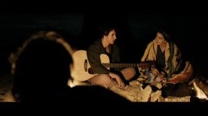 Playing guitar around the fire