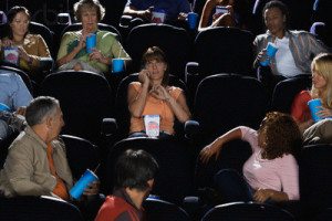 Woman Talking on Cell Phone During Movie